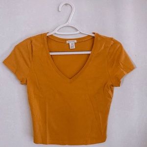 yellow colored cropped T shirt